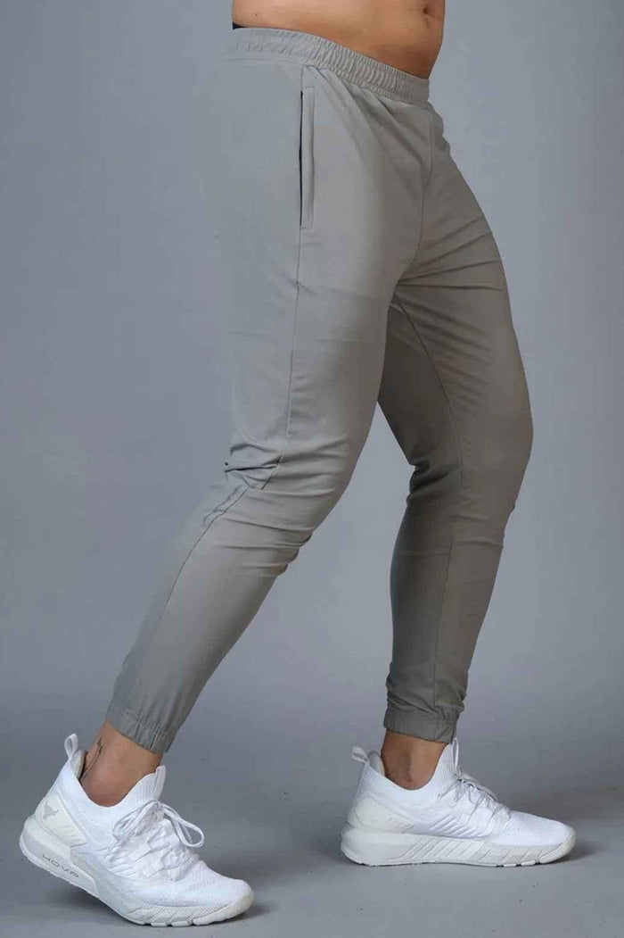 Light grey nylon joggers from Fuaark Nz featuring a relaxed fit and adjustable waistband, ideal for casual wear.