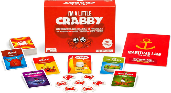 Red game box with cartoon crab, colorful cards with puns, small red crab tokens, and an instruction manual.