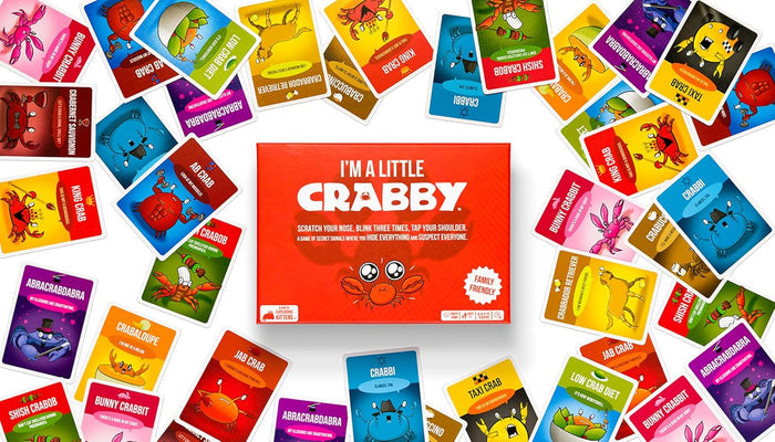 Red I'm A Little Crabby game box surrounded by colorful illustrated cards featuring whimsical crab characters.