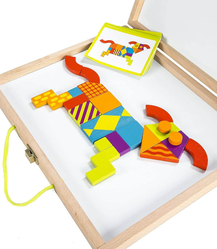 Colorful magnetic blocks forming a patterned dog on a whiteboard inside a wooden case with design cards.