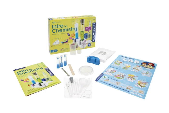 Yellow chemistry kit box with test tubes, beaker, funnel, petri dish, manual, and a colorful lab safety poster.