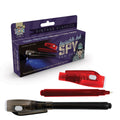 Purple vintage spy pen box next to a black pen and a red pen with its light-up cap removed showing a white felt tip.