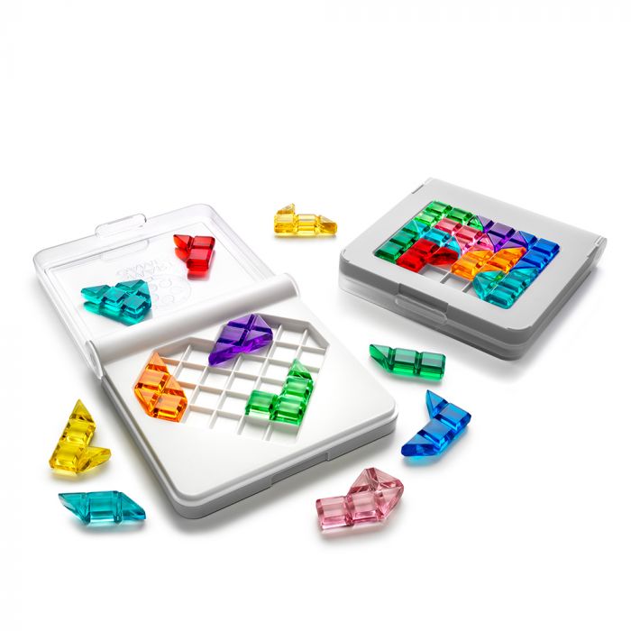 Vibrant, translucent puzzle pieces in a white heart-shaped tray and scattered around two compact white game cases.