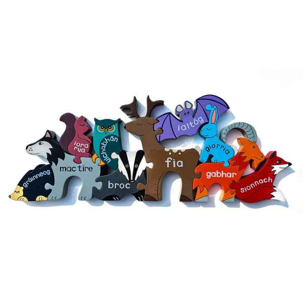 Colourful wooden animal shapes with Irish names, including a deer and fox, interlocking on a white background.