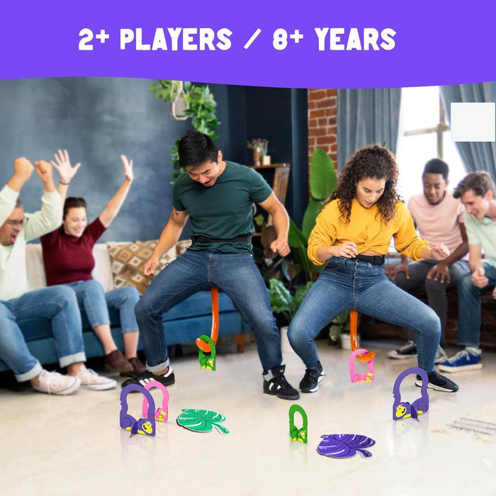 Two players wear orange monkey tails to hook colorful plastic monkeys off the floor during a lively party.