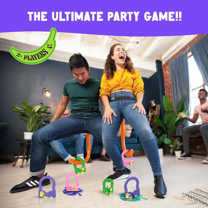 People wearing inflatable orange monkey tails try to hook colorful plastic monkeys from the floor at a party.