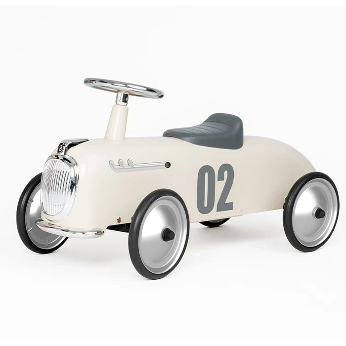 Ivory vintage-style ride-on car with chrome grille, grey seat, and number 02 on the side.