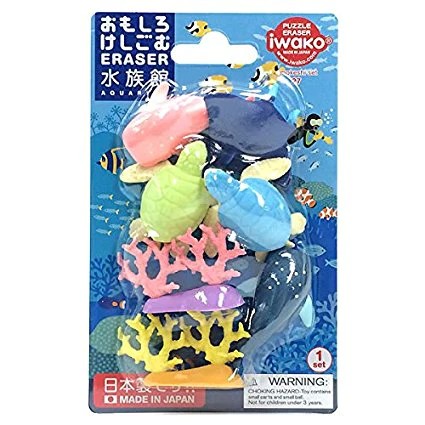 Colorful sea creature puzzle erasers with turtles, rays, and coral in blue ocean-themed blister packaging.