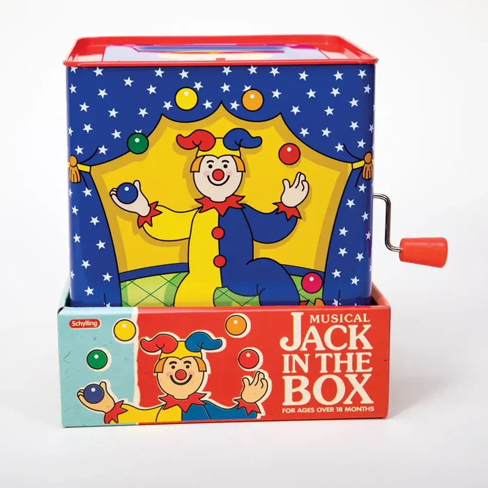 Blue tin musical jack-in-the-box with a juggling clown illustration and red hand crank in circus-themed packaging.