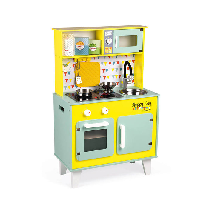 Yellow and mint wooden play kitchen with microwave, stove, oven, and sink against a colorful bunting backsplash.