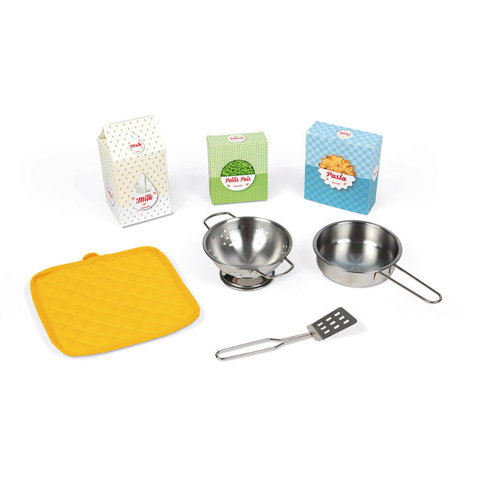 Toy kitchen accessories: stainless steel pan, colander, spatula, yellow potholder, and cardboard play food boxes.