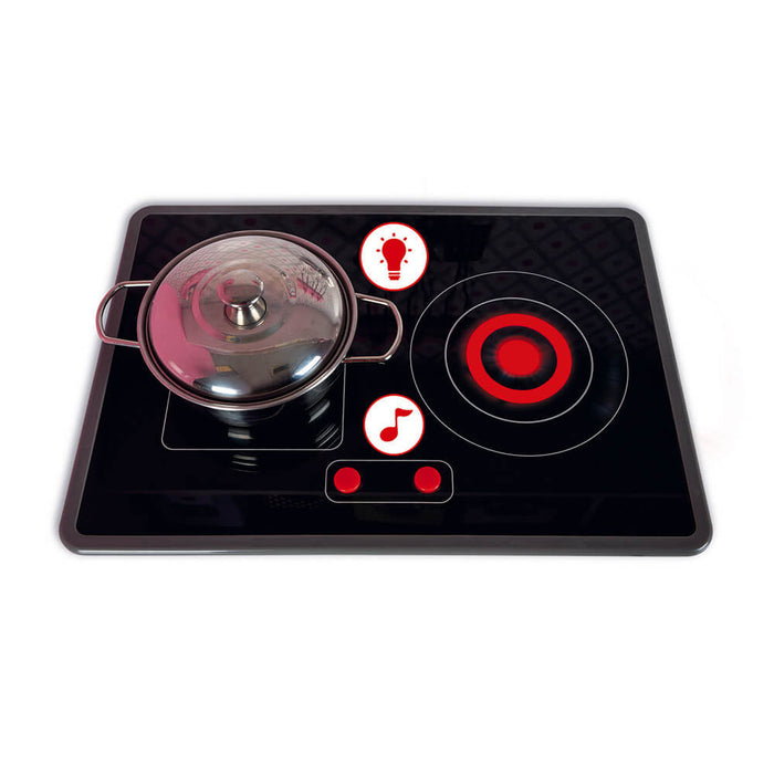 Toy stove top with a silver pot, red glowing burner, and light and sound icons on a black surface.