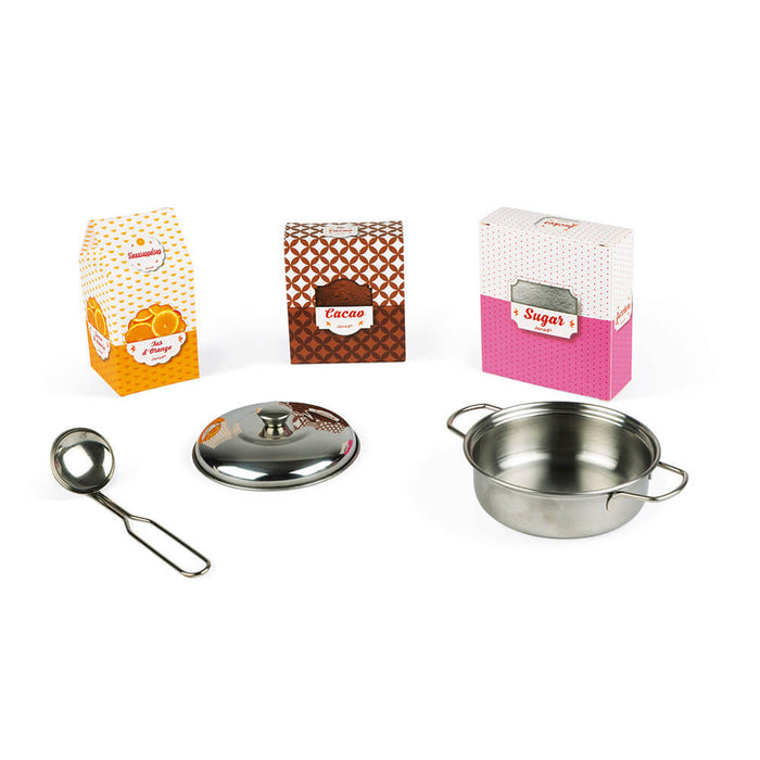 Colorful play food boxes for juice, cocoa, and sugar with a silver metal pot, lid, and ladle.