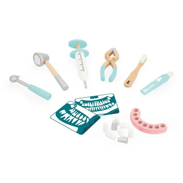 Wooden toy dentist set with light blue tools, toothbrush, pink dentures, tooth pieces, and X-ray cards.