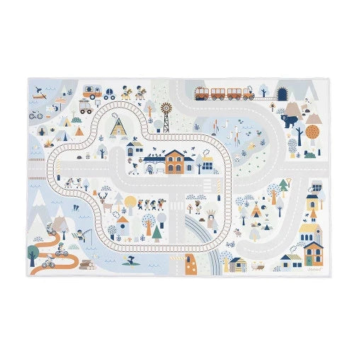 Rectangular play mat with a muted blue, grey, and yellow illustrated map of a mountain valley and town.