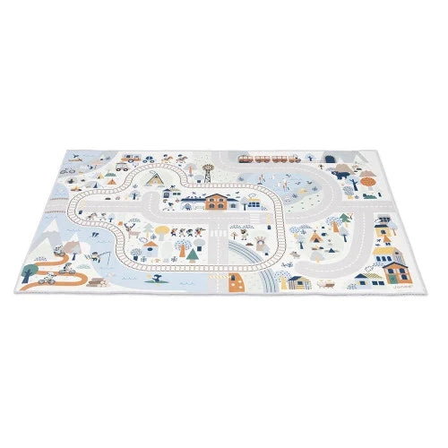 Rectangular play mat with a light blue mountain valley scene featuring winding roads, train tracks, a river, and houses.