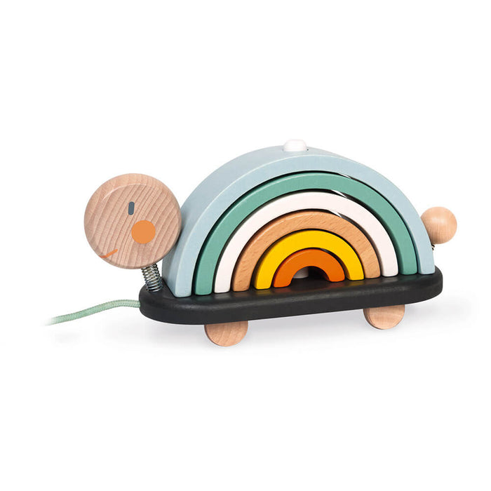 Wooden turtle pull toy with five colorful nested arches on a black base with wheels and a spring-mounted head.