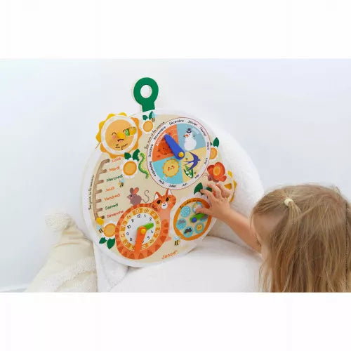 Child uses a round wooden calendar toy with colorful dials for time, seasons, and weather on a white background.
