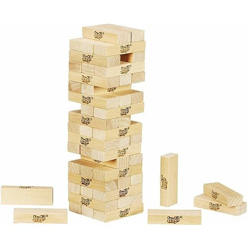 A tower of stacked, rectangular light-wood blocks with some pieces removed and scattered around the base.
