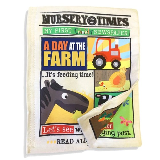 Cream cloth baby book designed like a newspaper with farm illustrations of a red tractor, horse, and yellow chicken.
