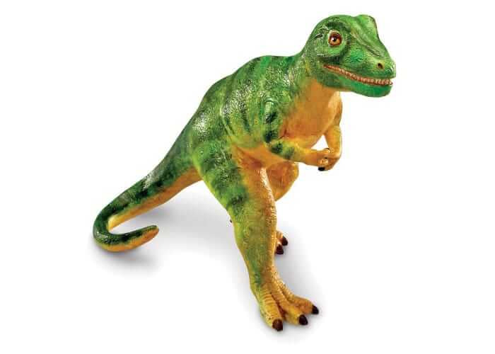 Textured green and orange dinosaur toy with small arms and a thick tail, standing in a bipedal pose.