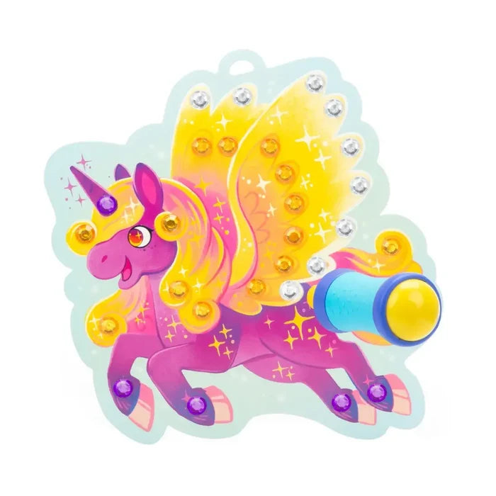 Pink winged unicorn with yellow wings and mane, decorated with sparkly gems and a blue and yellow gem applicator tool.