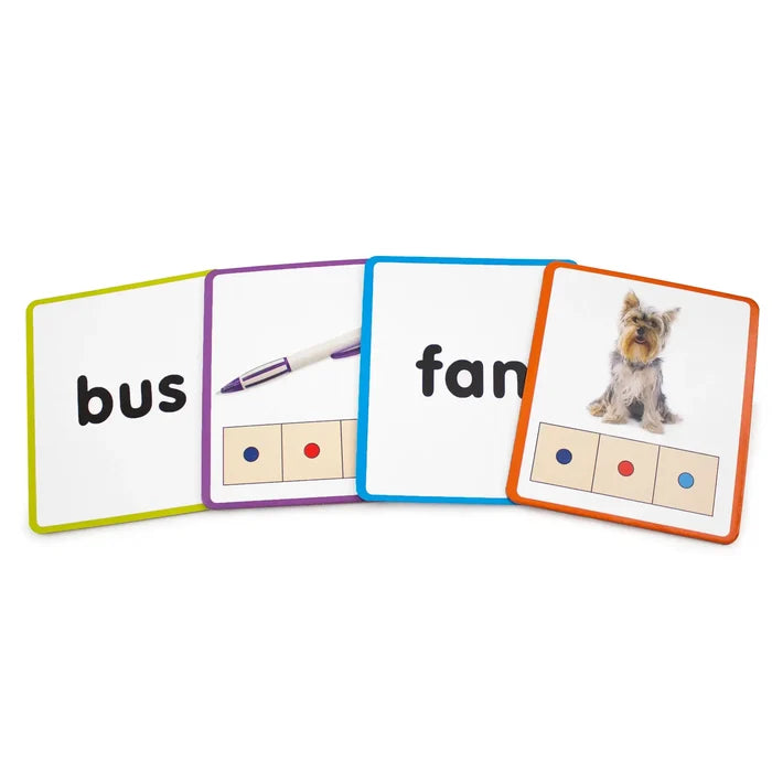 Four colorful square learning cards displaying the words bus and fan, alongside photos of a pen and a dog.
