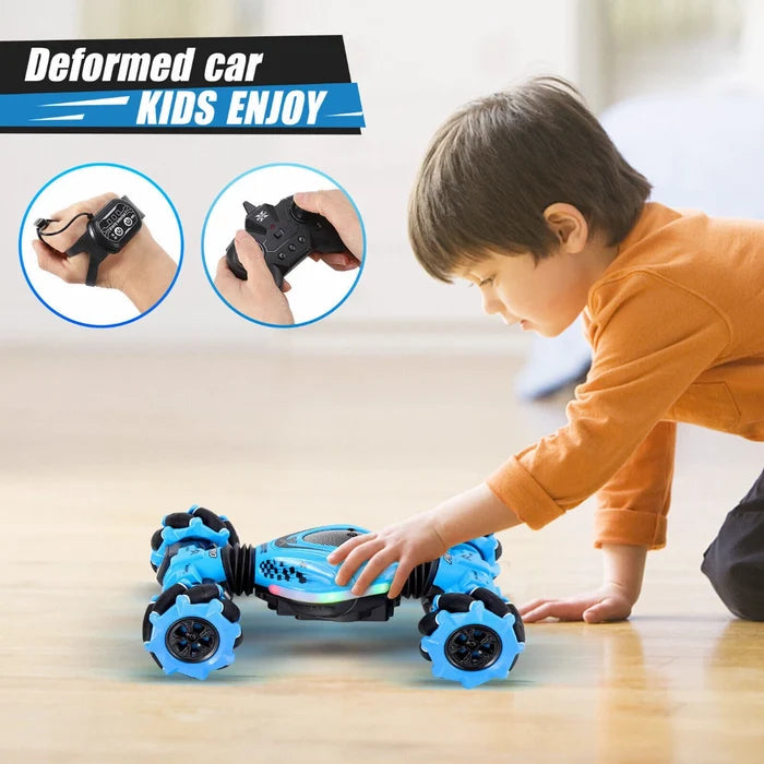 Blue twisting stunt car with mecanum wheels, shown with a wrist sensor and handheld remote as a child plays.