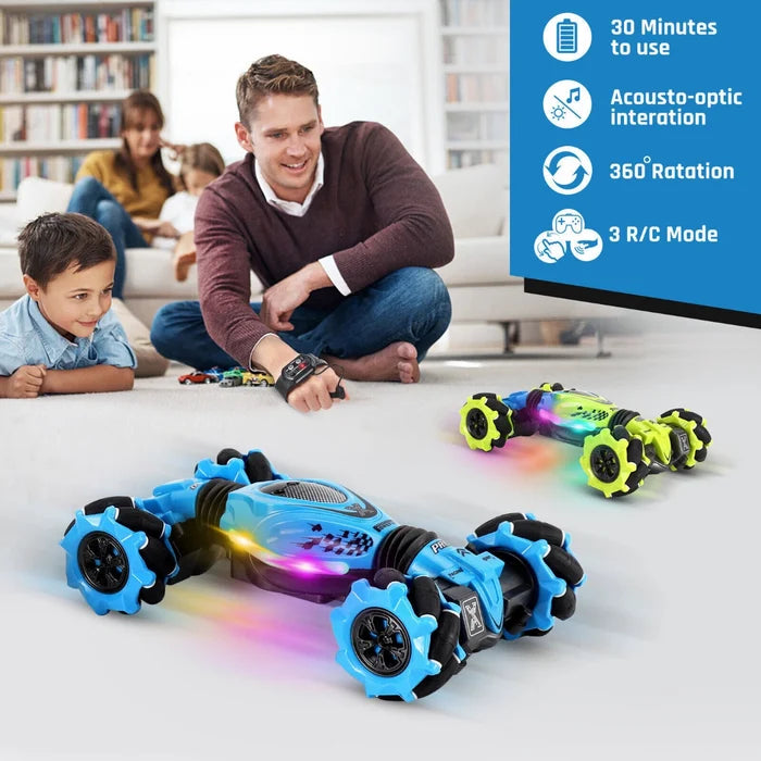 Blue and green light-up RC stunt cars with unique wheels, operated by a man's wrist-worn gesture controller.