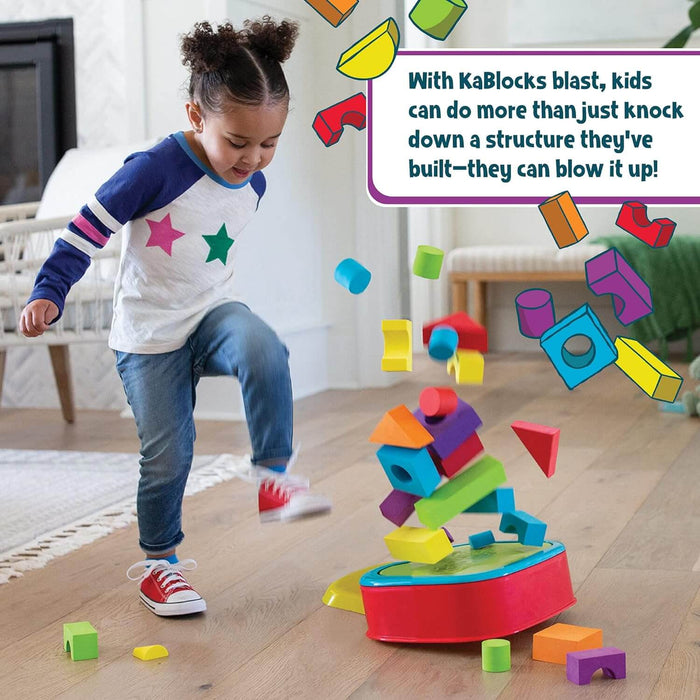 A child stomps on a red plastic base, launching colorful foam blocks of various shapes into the air.