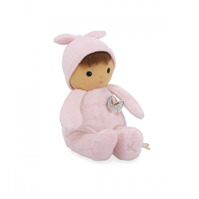 Plush baby doll in a soft pink fuzzy onesie and bunny-ear hat with a butterfly patch on the chest.