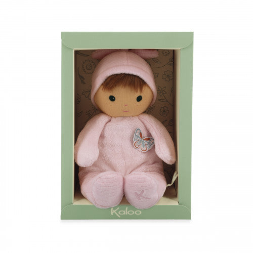 Pink plush doll with brown hair and a butterfly on its chest, sitting in a light green gift box.