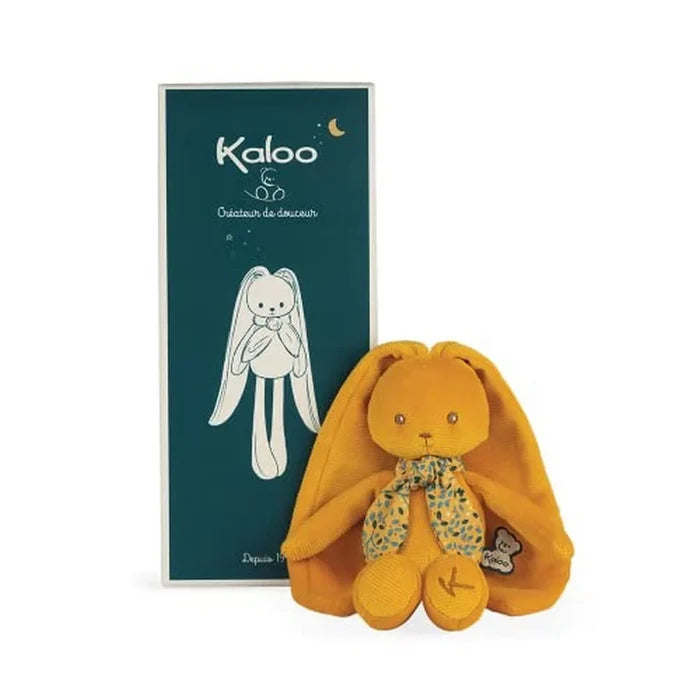 Ochre plush rabbit doll with long floppy ears and floral scarf next to its dark teal rectangular gift box.