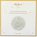 White box with gold trim and stars featuring a round plaster baby handprint mold in the center.