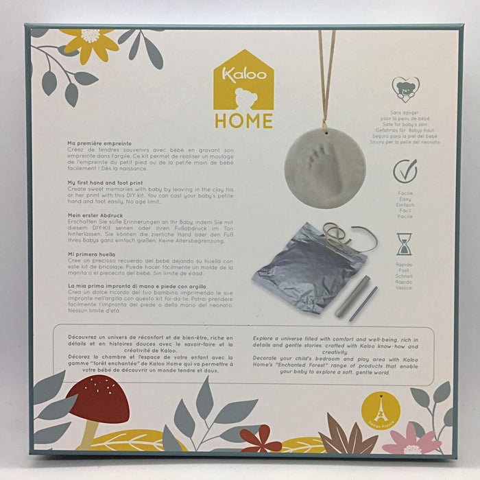 Botanical Kaloo box showing a baby footprint clay kit with a hanging ornament disk, silver bag, and tools.