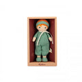 Soft fabric doll with orange hair wearing a green romper, shown inside a peach-colored gift box.
