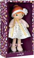 Plush doll with orange hair and star-patterned dress, displayed in a purple floral-printed window box.