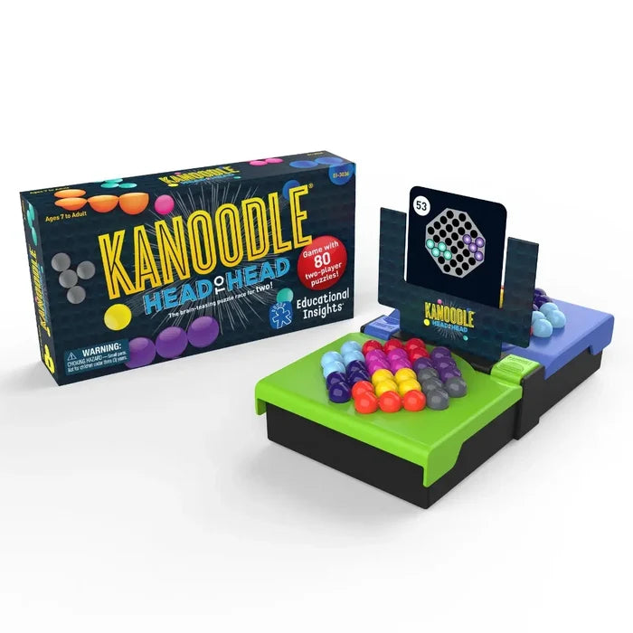 Packaging next to a two-player game board with colorful orb pieces and a challenge card on a center divider.