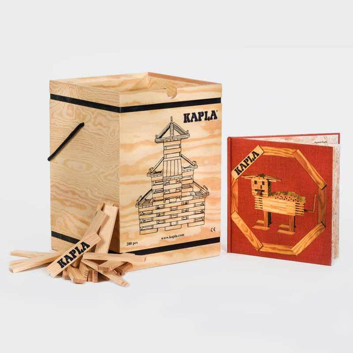 Pine crate with building planks, a tower illustration, loose blocks, and a red instruction book with animal art.