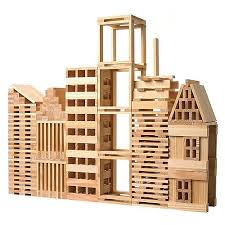 Intricate city skyline built from natural light wood planks featuring skyscrapers and a peaked-roof house.