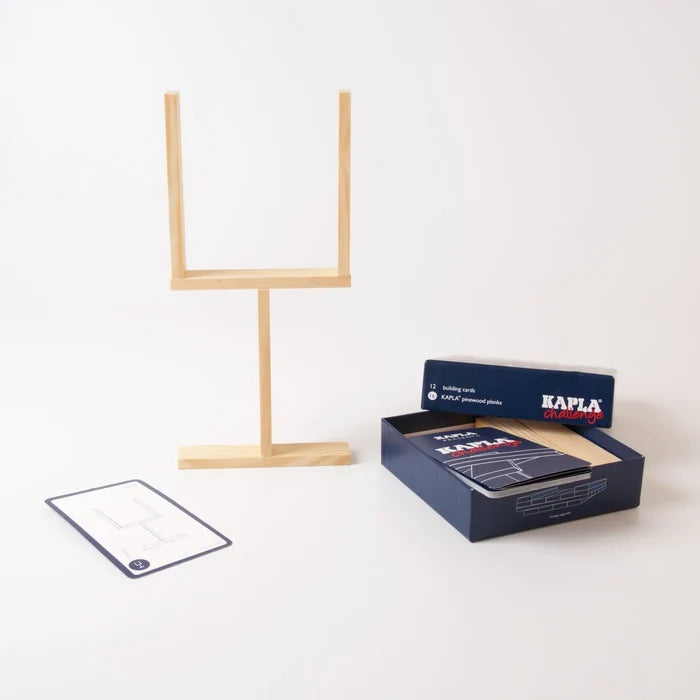 Light wood planks built into a goalpost next to a blue box and challenge cards on a white background.