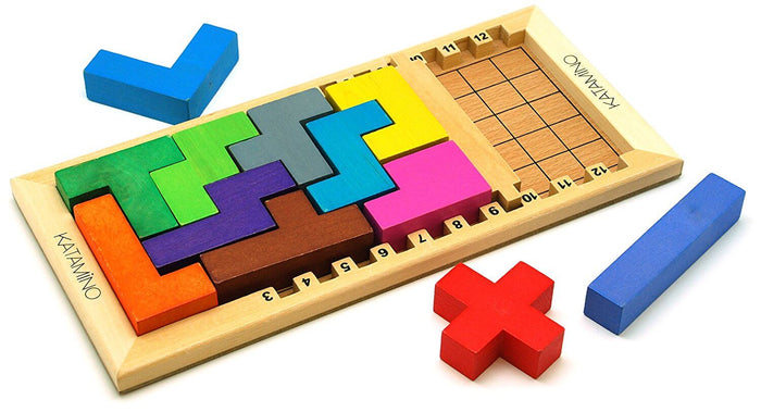 Colorful wooden blocks fit into a numbered wooden puzzle board with a red cross and blue bar pieces sitting nearby.