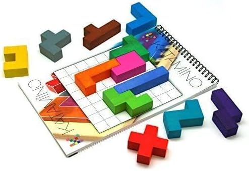 Colorful wooden blocks and a spiral-bound grid challenge book for the game Katamino on a white background.