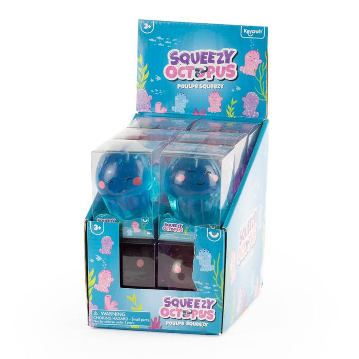 Teal squishy octopus toys with pink cheeks in clear boxes inside a blue display box with colorful underwater graphics.