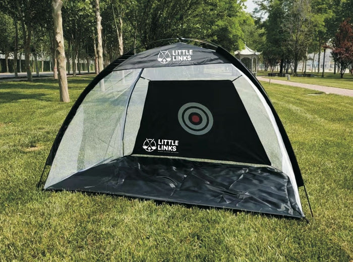 Black and white dome-shaped golf hitting net with a bullseye target and mesh sides on green grass.