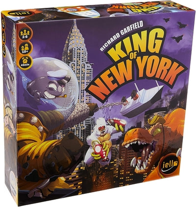 Purple square board game box showing a giant lizard, gorilla, and space monster attacking a city skyline.