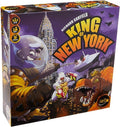 Purple square board game box showing a giant lizard, gorilla, and space monster attacking a city skyline.