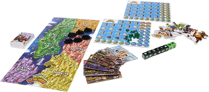 Colorful NYC map board game featuring monster cards, black dice, green energy cubes, and character tokens.