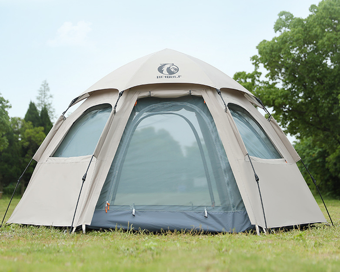 Beige ECOTREK large hexagon double-layer waterproof camping tent set up outdoors, showing its spacious design and sturdy construction.