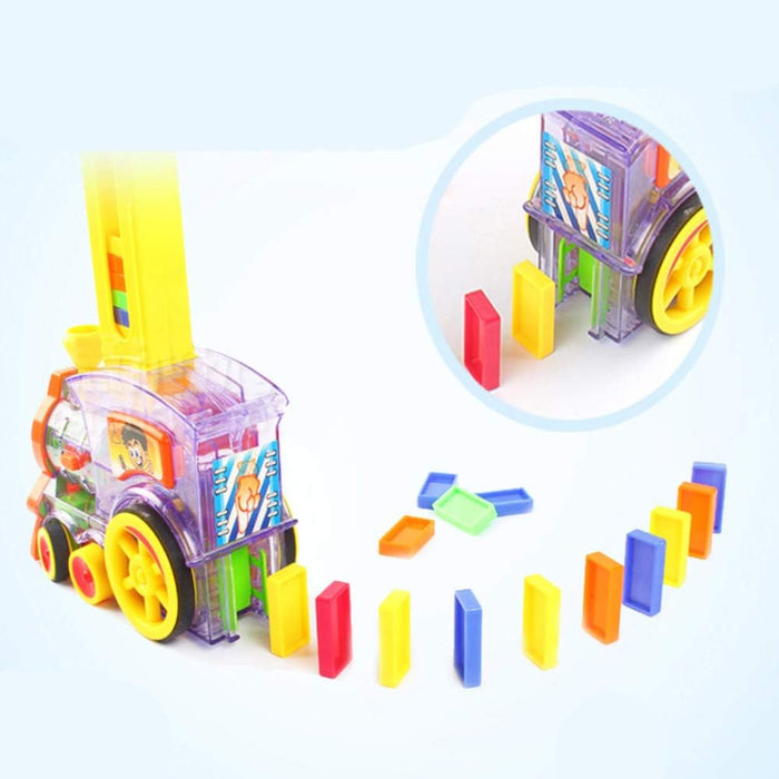 Transparent purple toy train laying colorful dominoes in a line, with a vertical yellow loader and close-up inset.